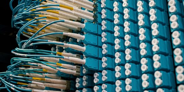 High-density fibre-optic cables connected to a network switch, illustrating the connectivity infrastructure planned for India's AI data-centre corridors