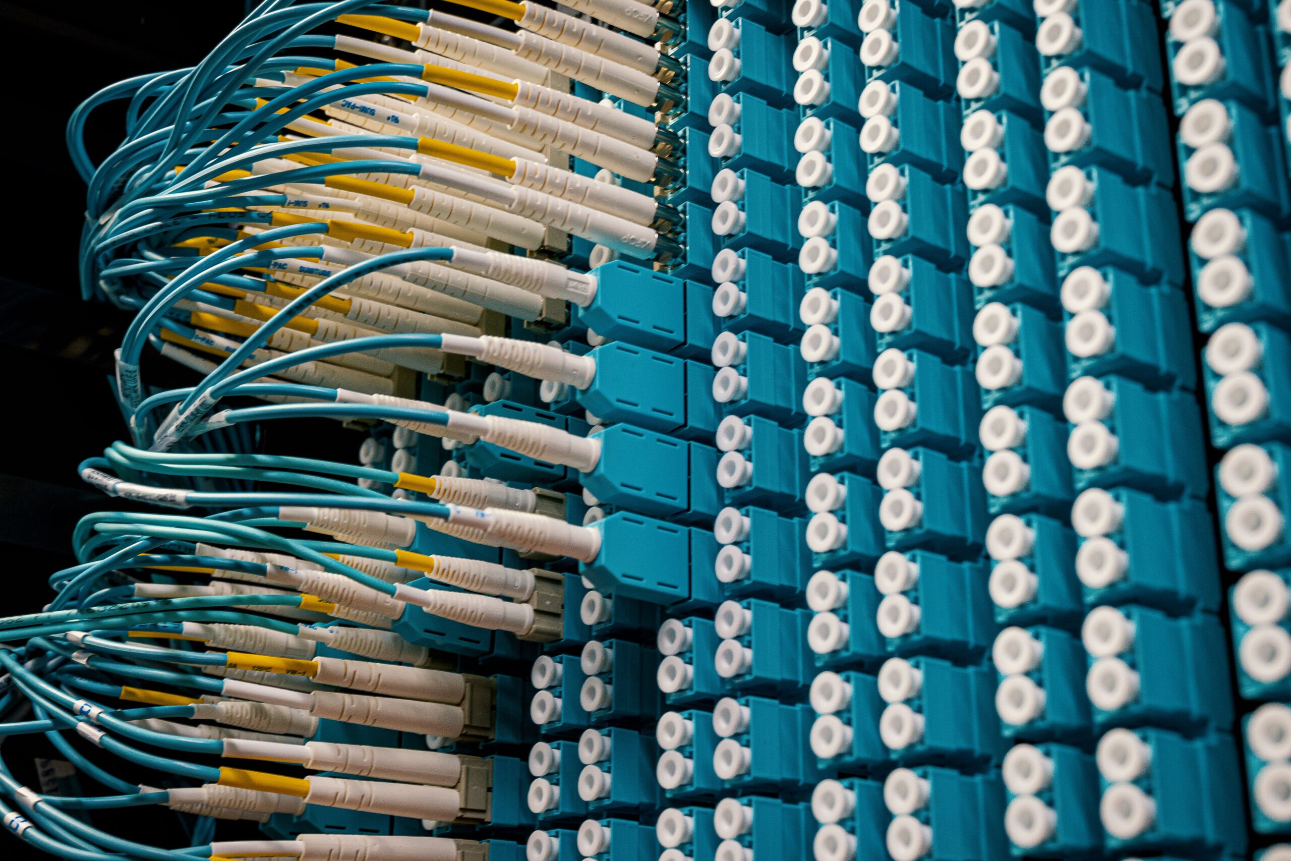 High-density fibre-optic cables connected to a network switch, illustrating the connectivity infrastructure planned for India's AI data-centre corridors